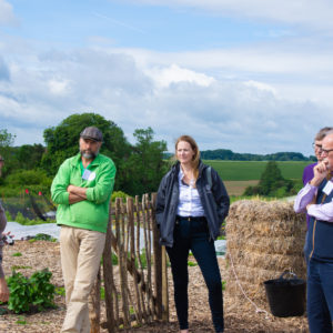 Attendees listen to Rachel Wheatley talk about the GREAT Zerodig site at the market garden