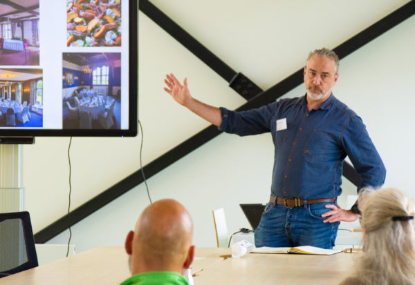 Darren Sharp speaking in front of an audience
