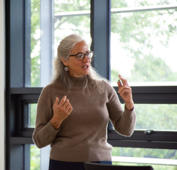 Portrait of Rachel Wheatley speaking in front of an audience
