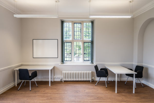Office space with two desks and chairs, with portrait window
