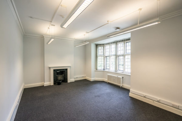 empty office space with fireplace and large window
