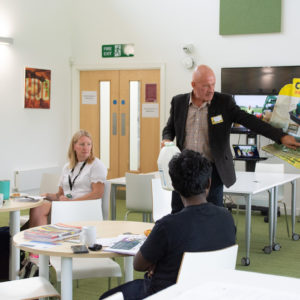 Photo of Nigel Chute presenting in front of a business breakfast audience