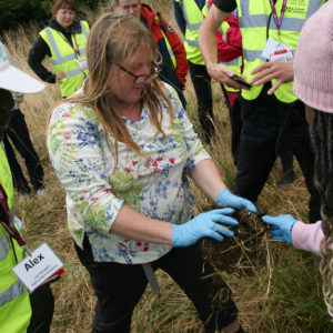 farmer and researchers examining soil